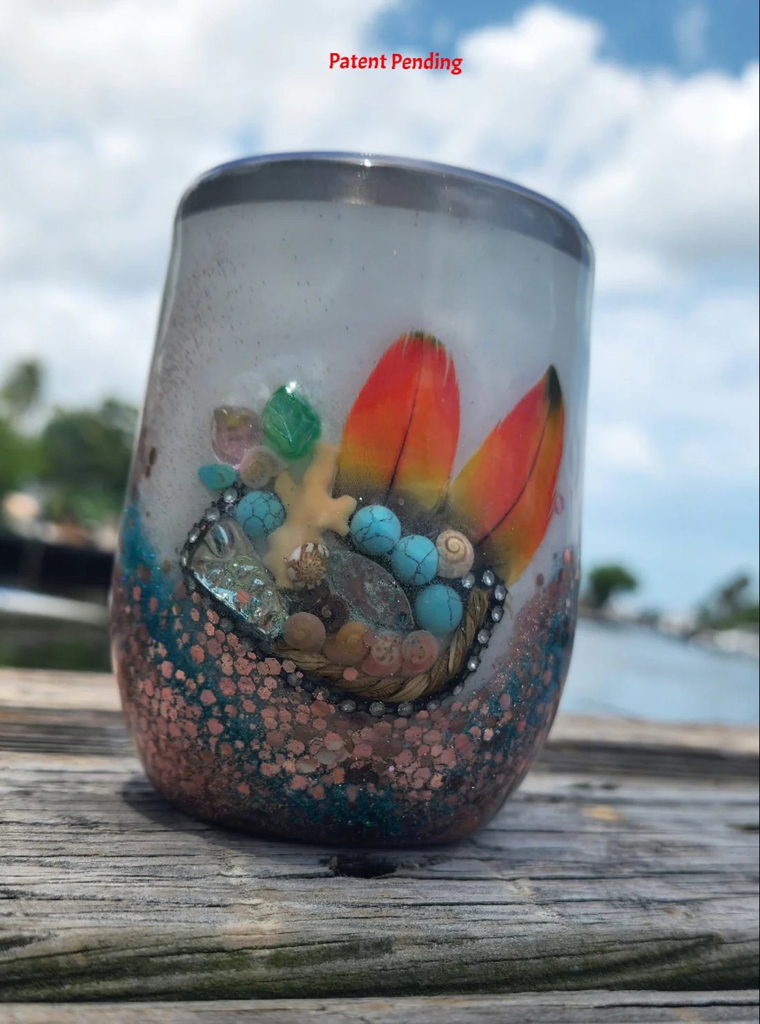 Handmade coastal glitter tumbler rose gold teal finish on waterfront dock