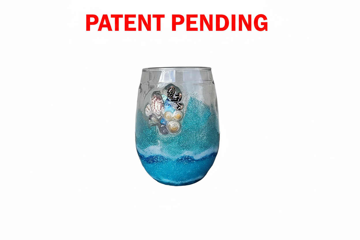 Decorative stemless wine  glass with seashells and blue and white design on a white background