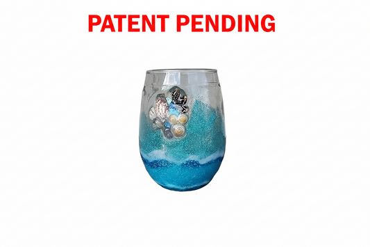 Decorative stemless wine  glass with seashells and blue and white design on a white background