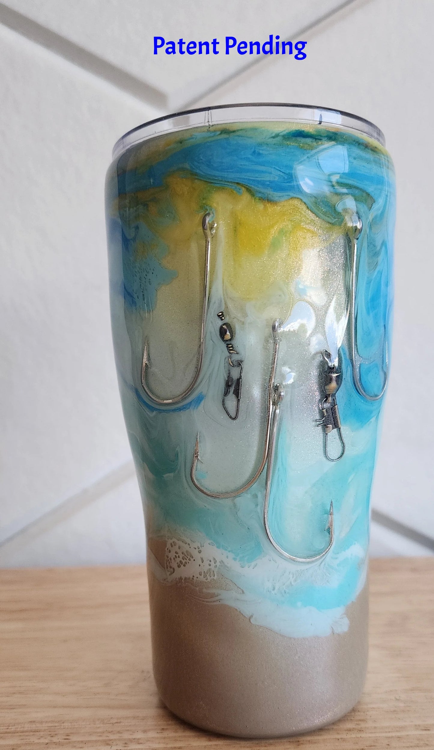 Turquoise ocean wave fishing hook tumbler 20oz indoor front view, Hook & Tumble™ Patent Pending
