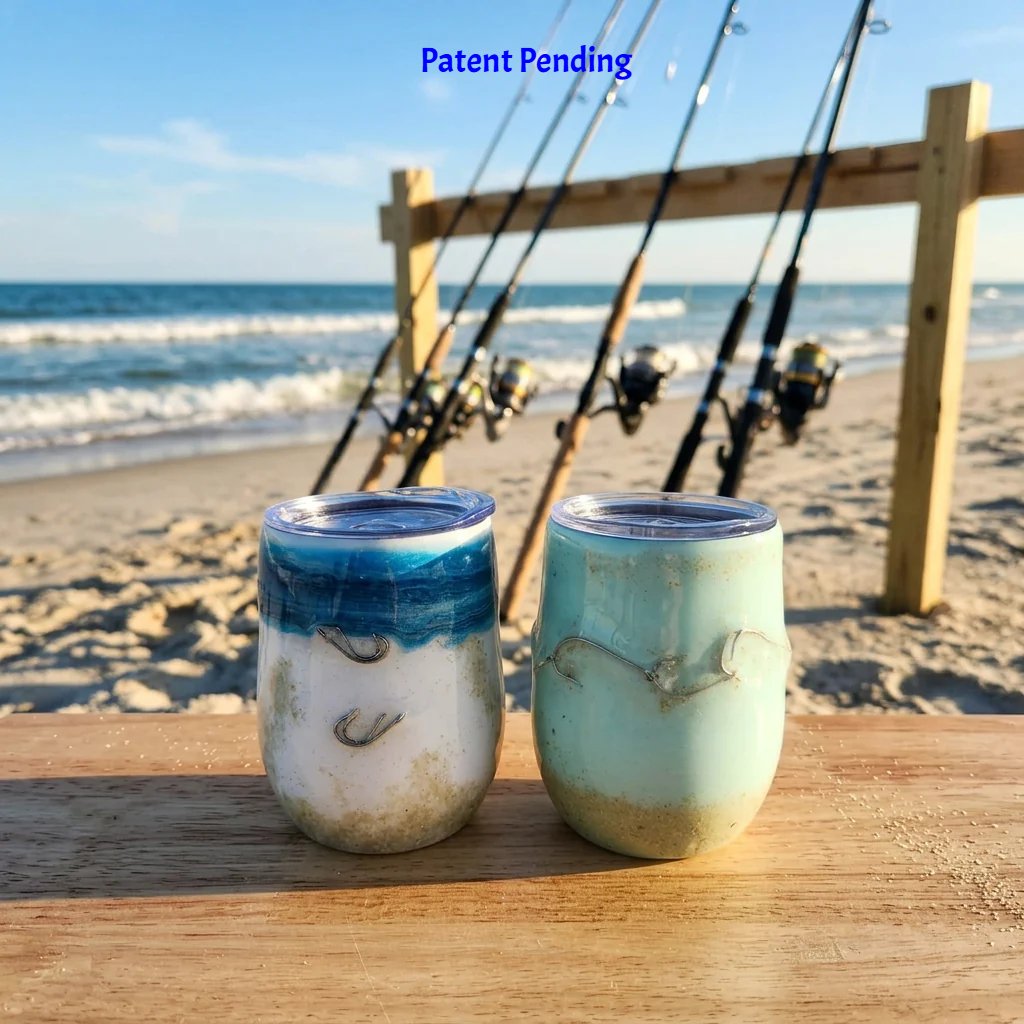 Two handmade 12oz fishing hook tumblers, one ocean blue fade and one teal, with real fishing hooks and sand on a beach with fishing rods