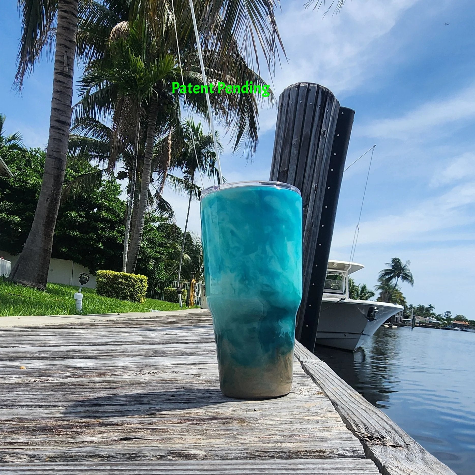 Handmade 30oz teal Caribbean coastal fishing tumbler, back side view  - Hook & Tumble™ by SoFlo Boho Boutique, displayed on a South Florida marina dock with palm trees and water in the background.