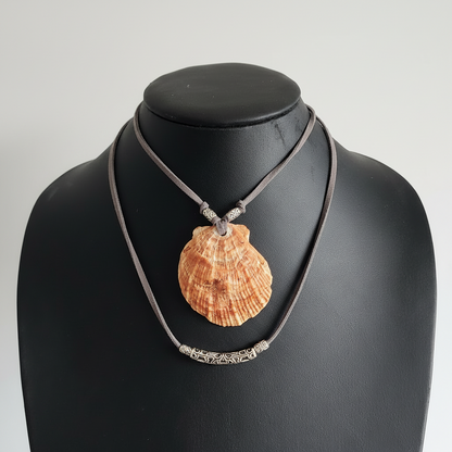 Adjustable lions paw choker necklace displated on a bust.