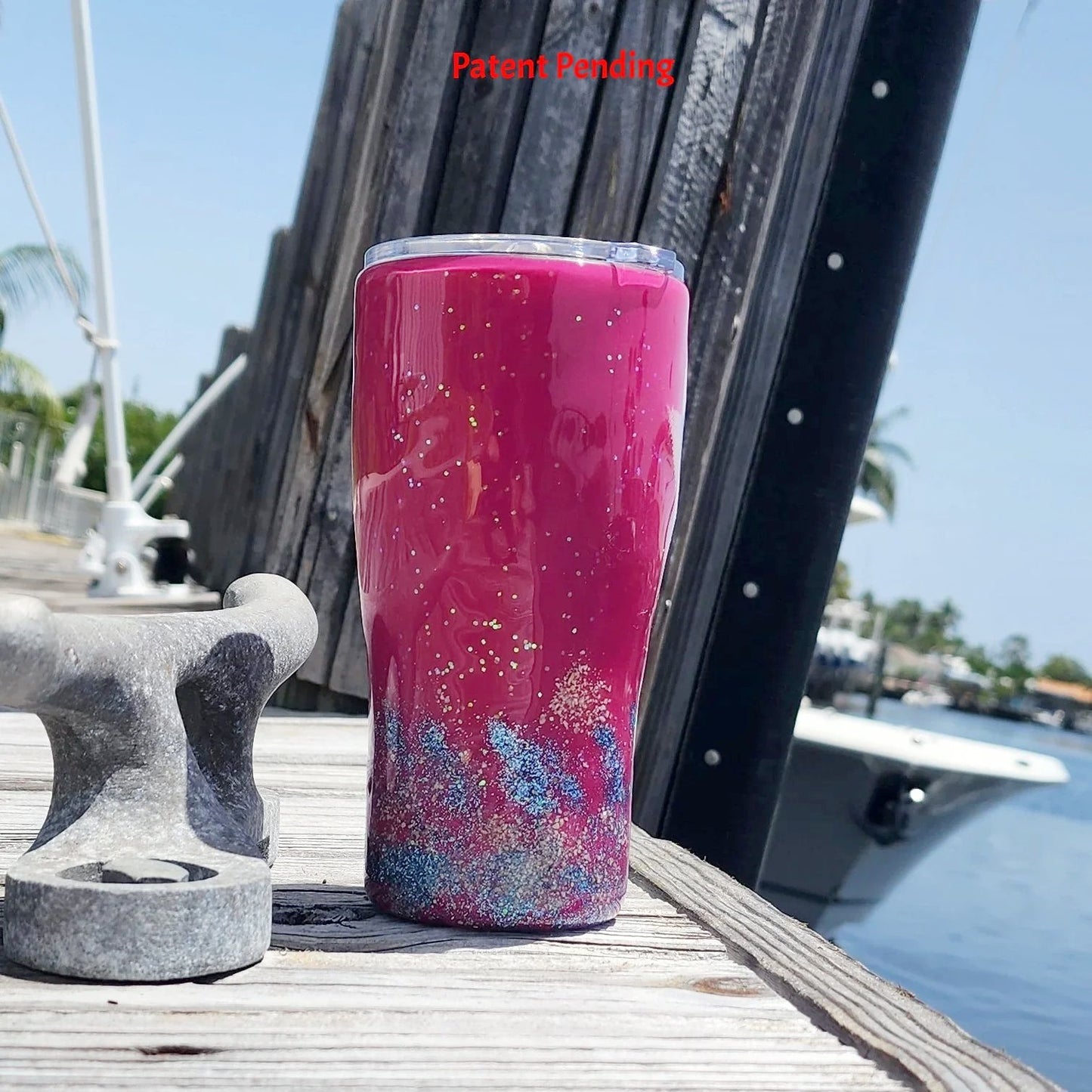Back view of the 20oz Saltwater Sips beach tumbler, displaying the clean, vibrant high-gloss magenta finish meeting the blue glittered tideline and textured real sand base.