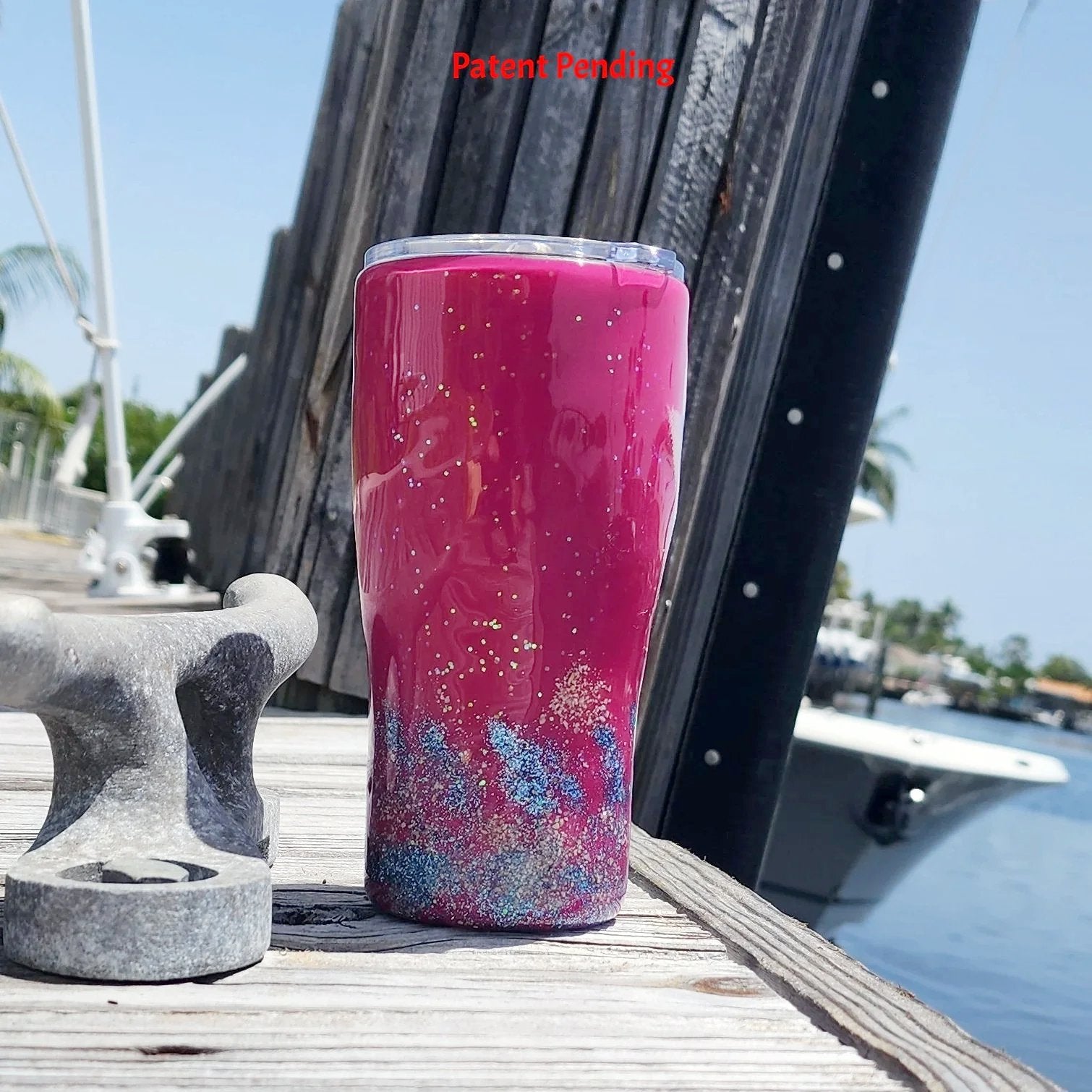 Back view of the 20oz Saltwater Sips beach tumbler, displaying the clean, vibrant high-gloss magenta finish meeting the blue glittered tideline and textured real sand base.
