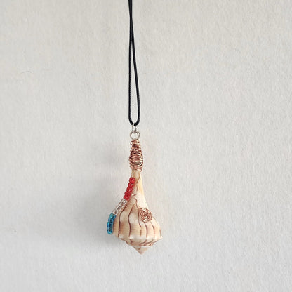 Lightning Whelk seashell pendant necklace hanging on black cord, full view showing copper wire wrap and shell point
