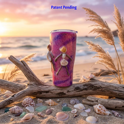 Handmade pink shell people tumbler on driftwood with seashells at the shoreline
