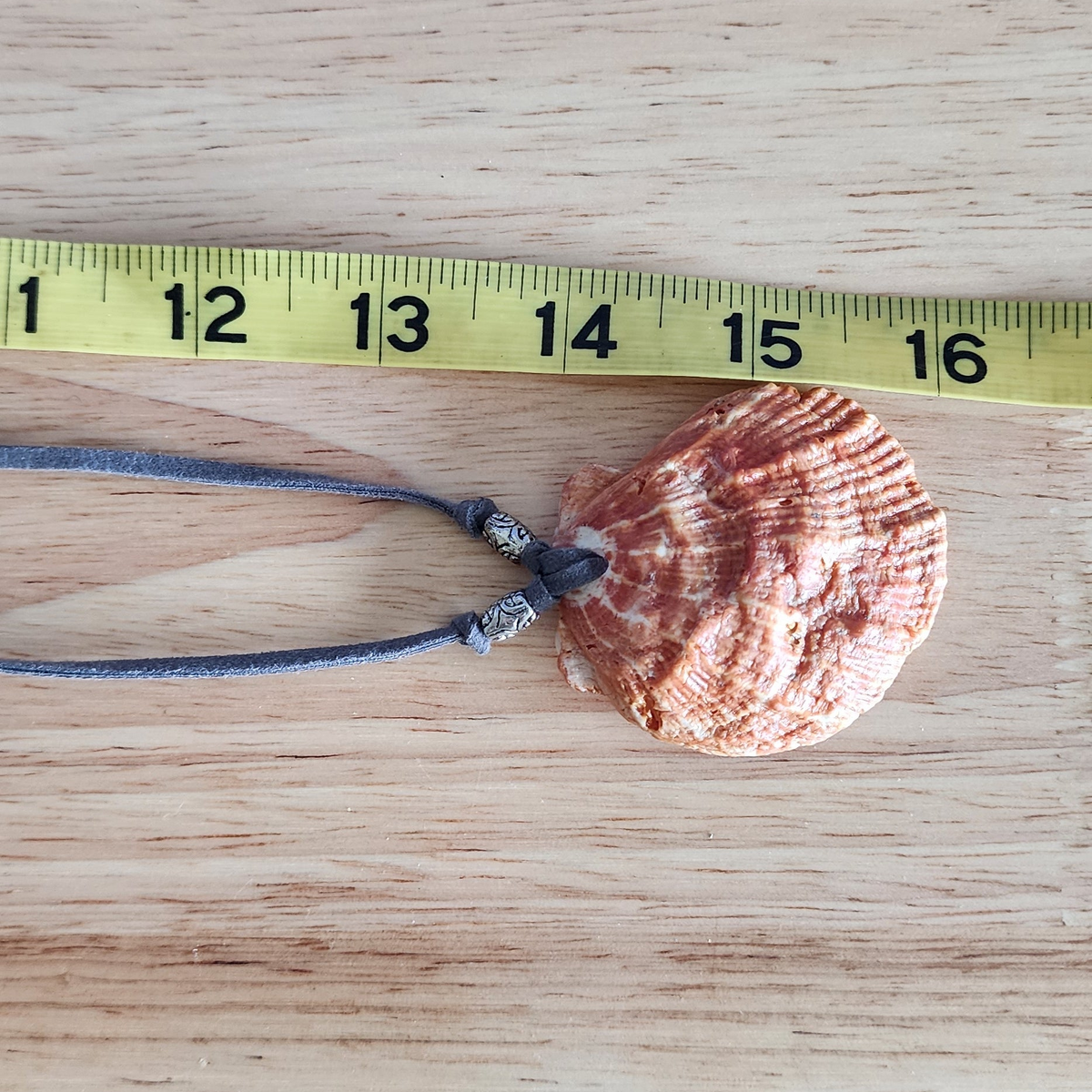 Adjustable choker necklace shown with measuring tape.