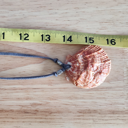 Adjustable choker necklace shown with measuring tape.