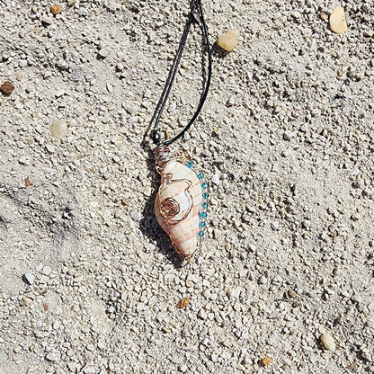 Handmade tulip shell pendant necklace with copper wire wrap, blue ceramic bead, and glass beads on cord