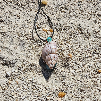 Handmade tulip shell pendant necklace with mixed metal wire wrap, turquoise beads, and wood accents on cord