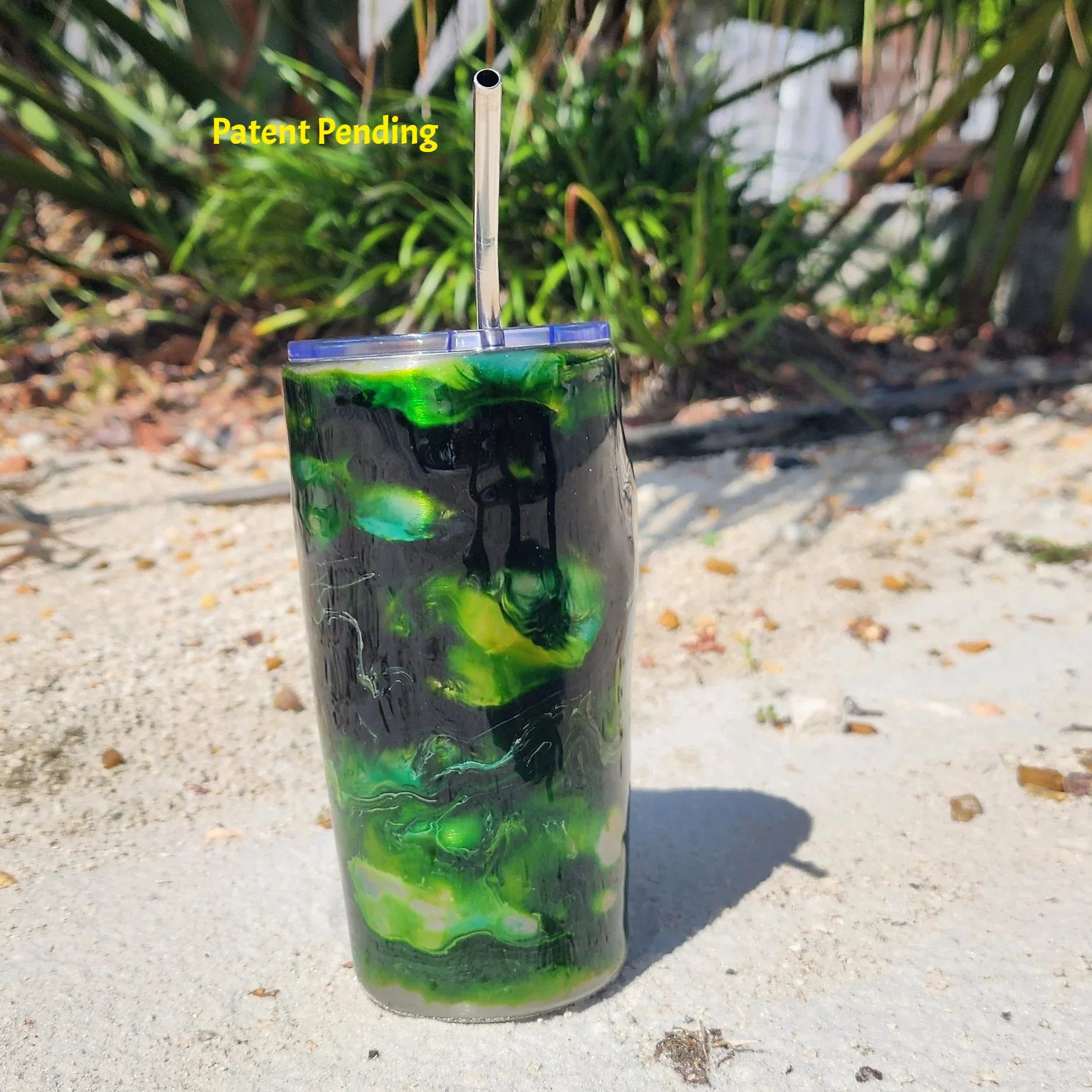 Hook & Tumble 20oz coastal tumbler in green tones lifestyle shot