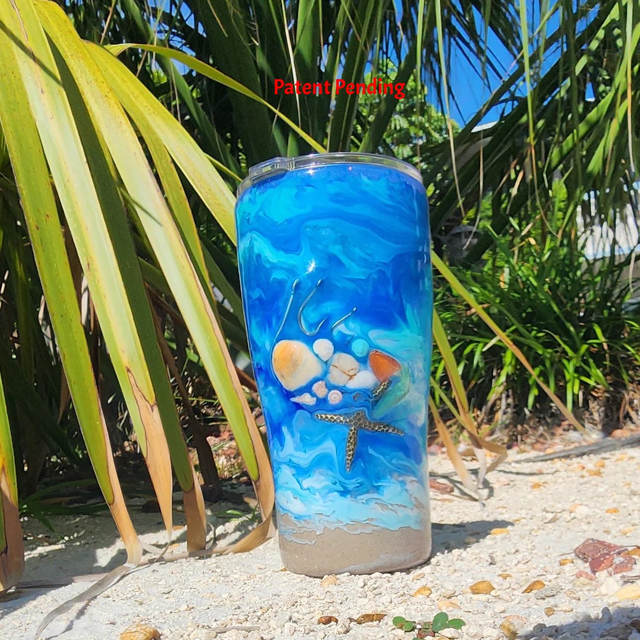 Blue ocean Hook & Tumble™ 20oz tumbler front view, real fishing hooks seashells starfish howlite sea glass, shimmer finish, Patent Pending