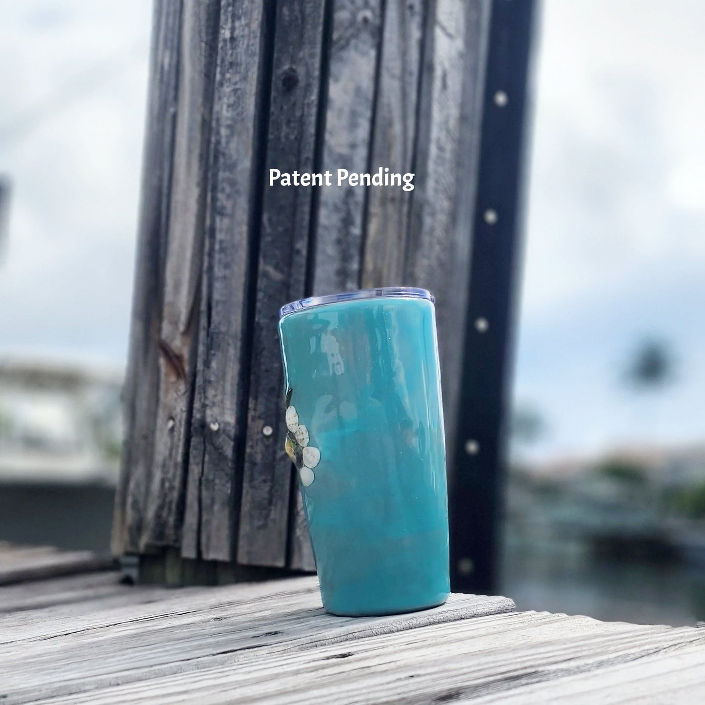 Left view of tapered stainless steel tumbler with real Florida seashells and starfish charm