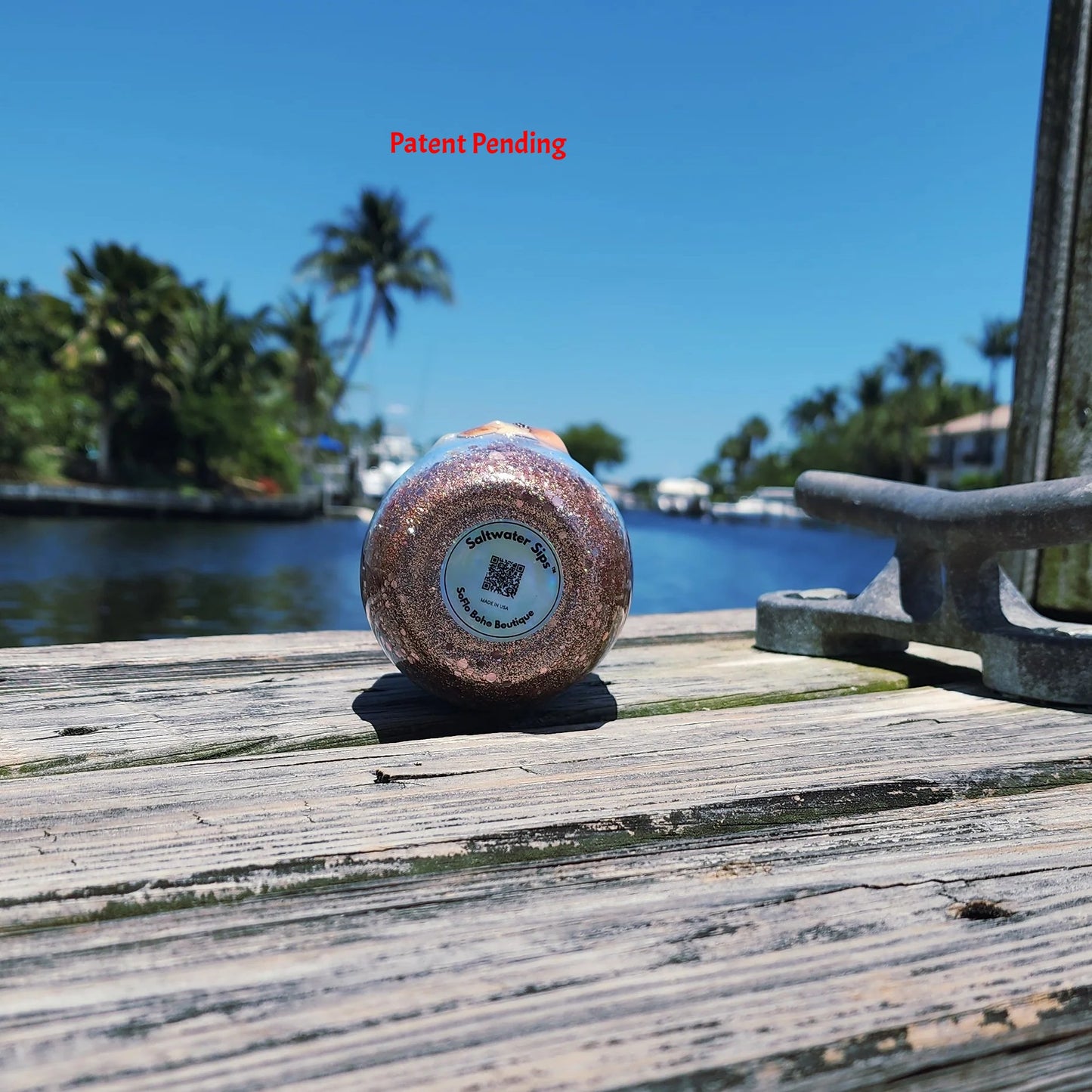 Bottom view of Rose Gold Saltwater Sips™ wine tumbler showing dense seashells, snail shell and rose gold glitter in clear epoxy resin