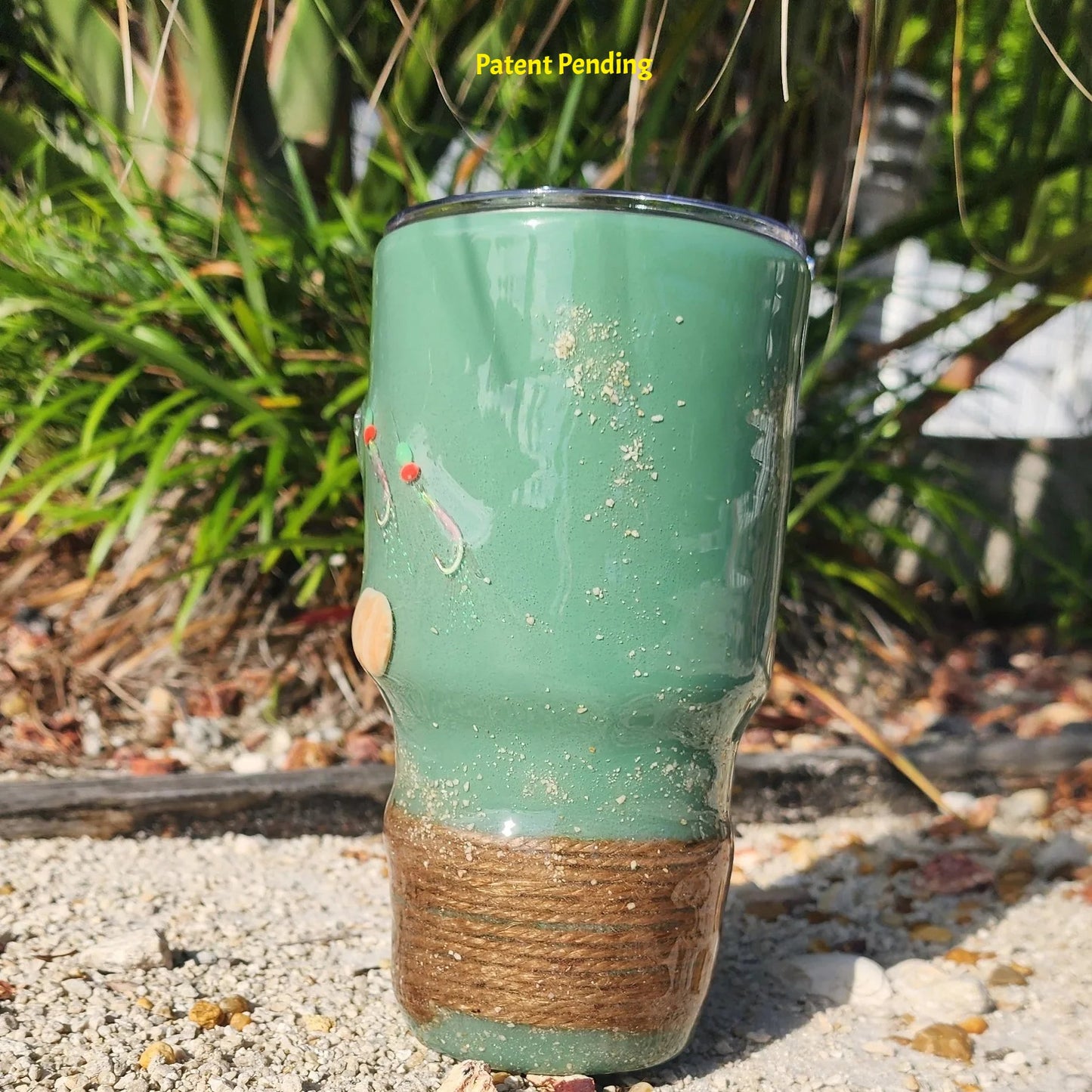 Marsh Tide 30oz Hook & Tumble fishing tumbler left side in sand 