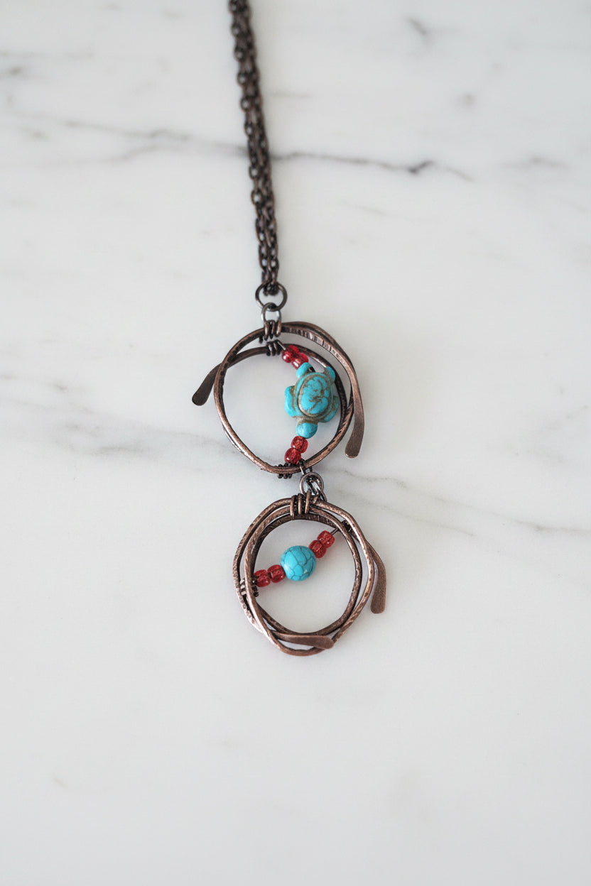 Copper pendant necklace with turquoise howlite turtle and red glass beads