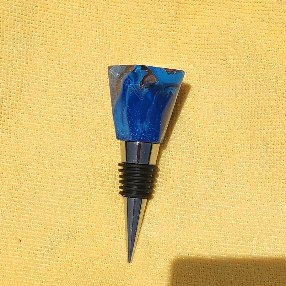 Geometric resin wine bottle stopper in sapphire blue, multiple angles