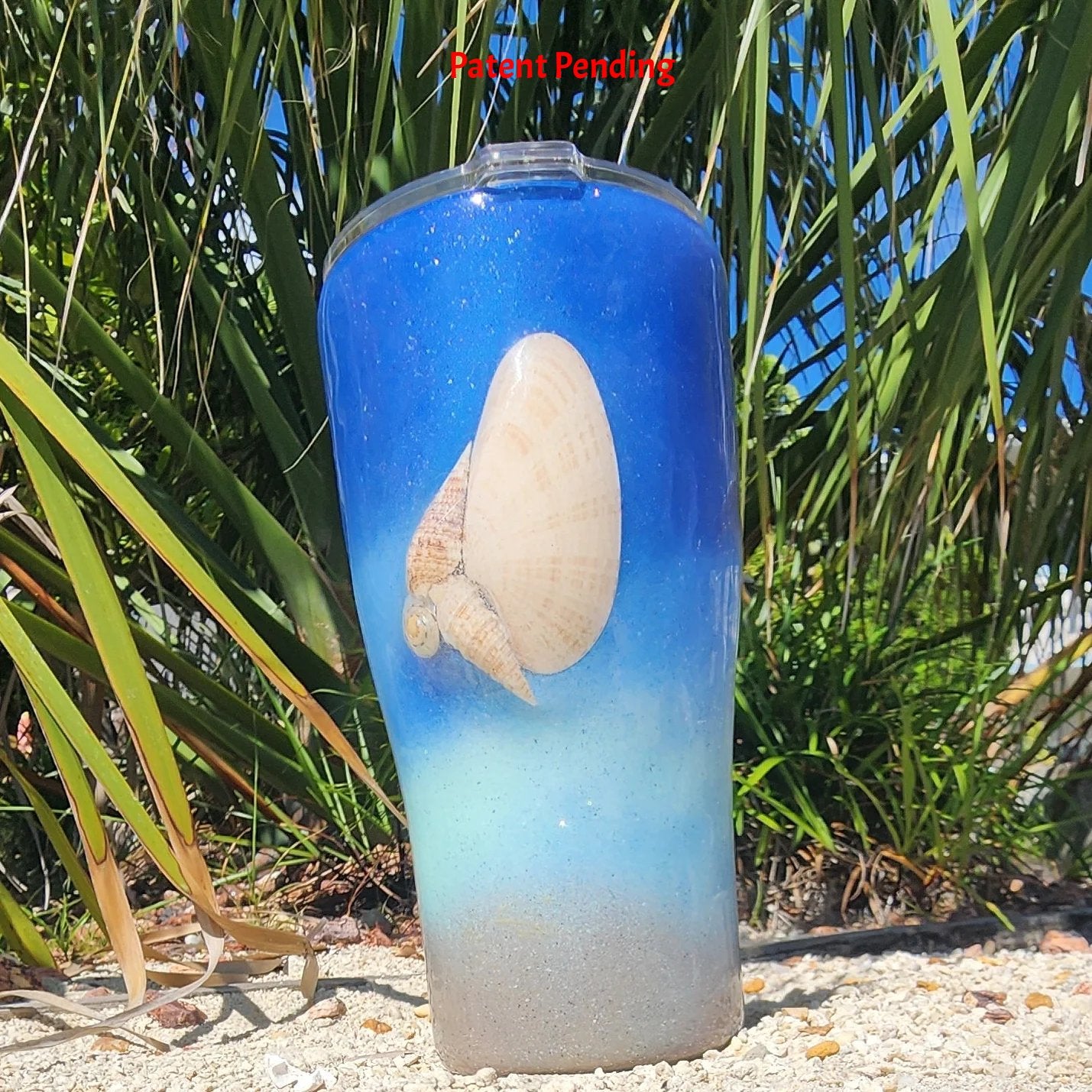 Blue ombre Saltwater Sips™ 20oz seashell tumbler front view, real Florida seashell centered, cobalt blue to sandy ombre, Patent Pending