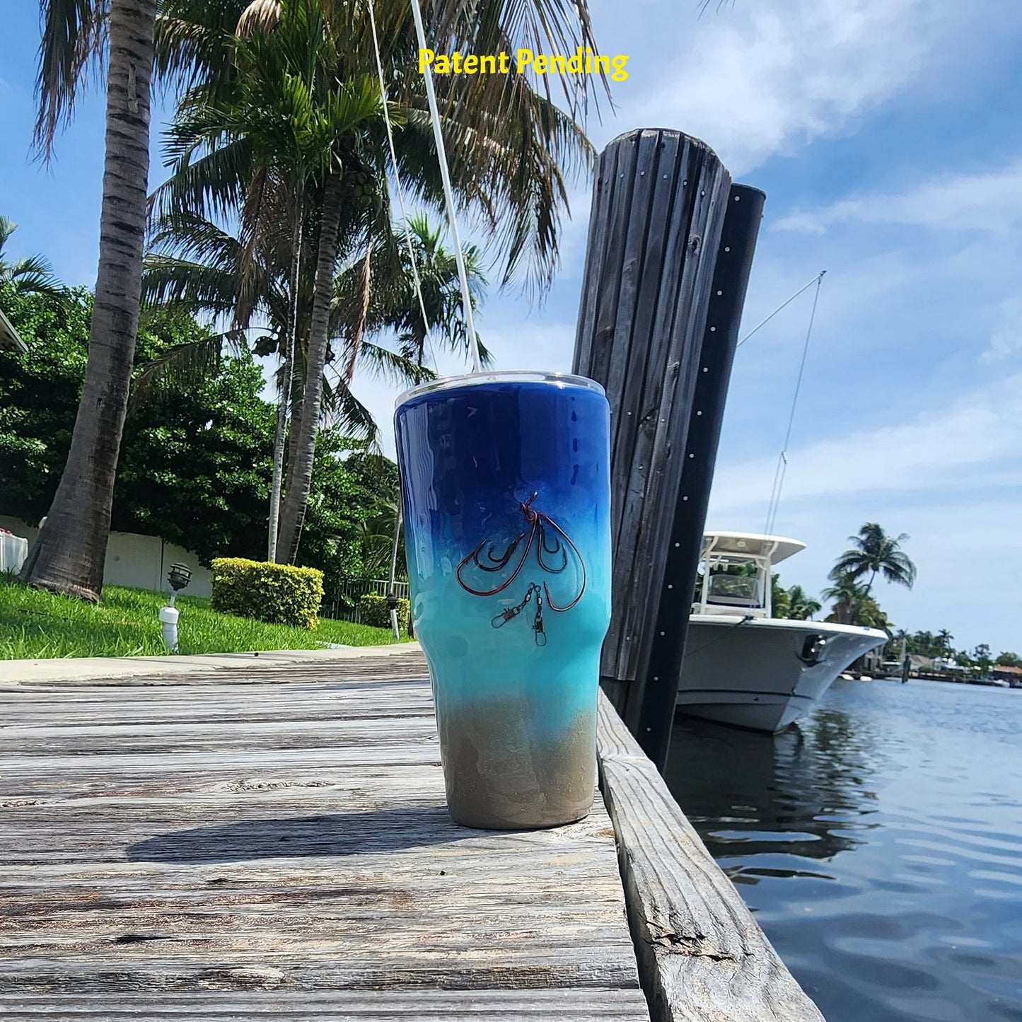 Shore to Sea Blue 30oz fishing tumbler front view on South Florida marina dock with palm trees and waterway. Hook & Tumble™ by SoFlo Boho Boutique, Patent Pending, handcrafted in South Florida.
