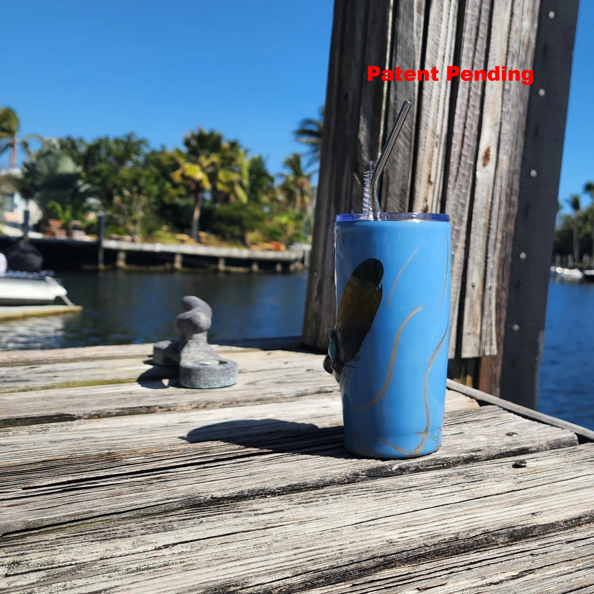 Blue Saltwater Sips seashell tumbler on dock by water – handmade coastal cowgirl drinkware 20oz