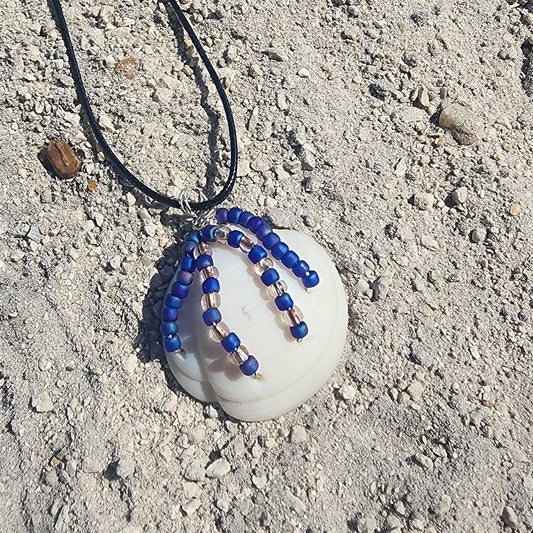 Handmade Lucina shell pendant necklace with silver wire wrap and purple bead strands