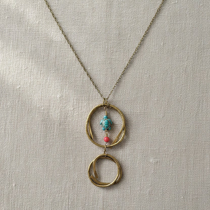 Close-up of hammered brass circles on handmade turtle pendant necklace