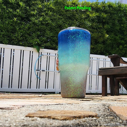 Right side view of Caribbean Glow Shell Glitter 30oz tumbler showing real seashell and silver starfish charm detail with holographic iridescent glitter. Saltwater Sips™ by SoFlo Boho Boutique, Patent Pending.