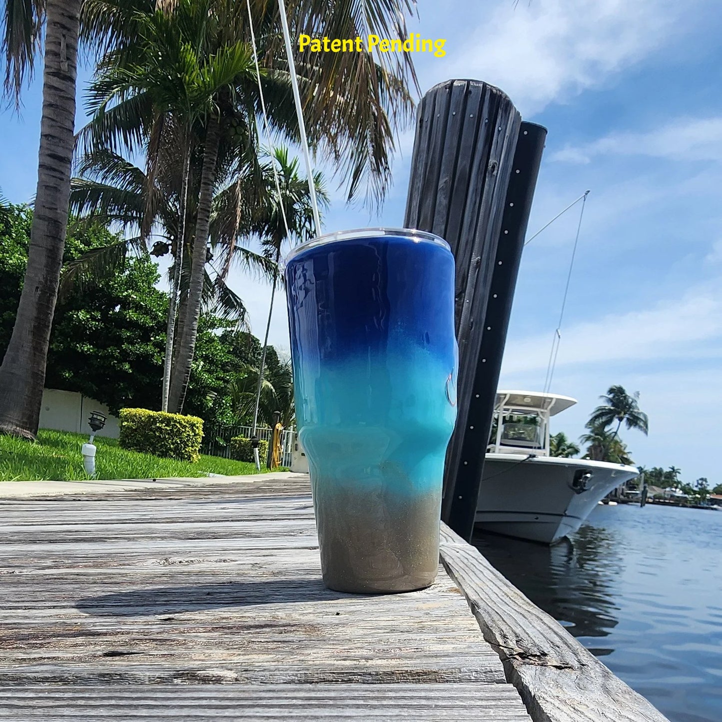 Left side view of Shore to Sea Blue 30oz fishing tumbler on South Florida marina dock showing coastal blue to sand color story. Hook & Tumble™ by SoFlo Boho Boutique, Patent Pending.