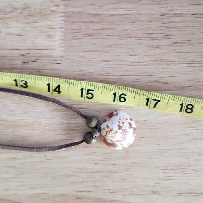 Adjustable choker necklace shown with measuring tape.