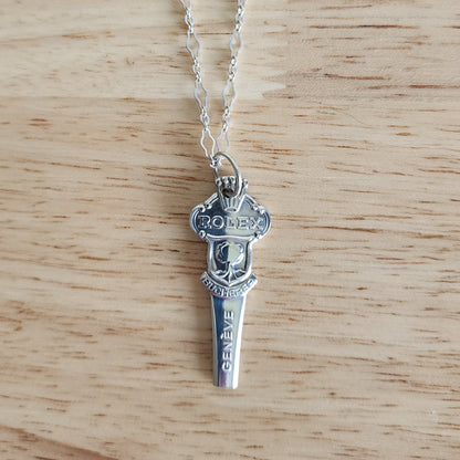 Rolex Bucherer vintage silver spoon handle pendant on wood surface, handmade necklace