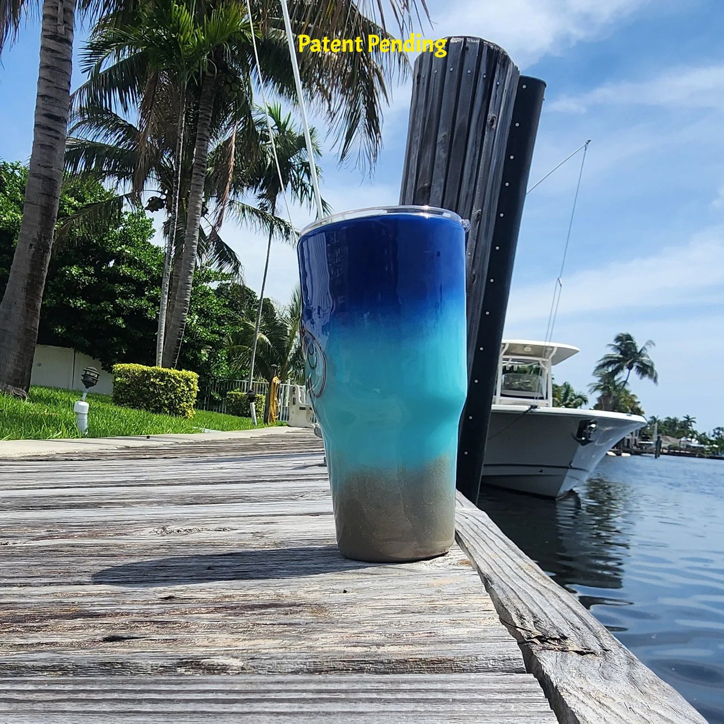 Right side view of Shore to Sea Blue 30oz fishing tumbler on South Florida marina dock showing saltwater fishing hooks and barrel swivel detail. Hook & Tumble™ by SoFlo Boho Boutique, Patent Pending.