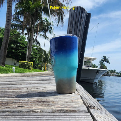 Right side view of Shore to Sea Blue 30oz fishing tumbler on South Florida marina dock showing saltwater fishing hooks and barrel swivel detail. Hook & Tumble™ by SoFlo Boho Boutique, Patent Pending.