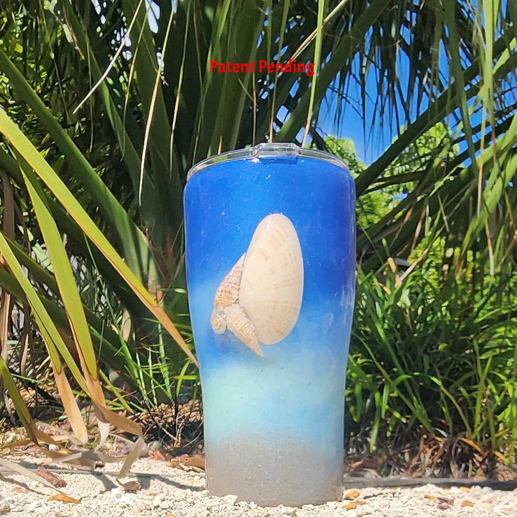 Blue ombre Saltwater Sips™ 20oz seashell tumbler front view, real Florida seashell centered, cobalt blue to sandy ombre, Patent Pending