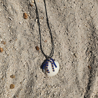 Handmade Lucina shell pendant necklace with silver wire wrap and purple bead strands