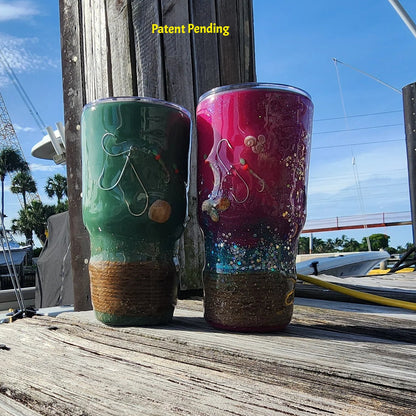 Green and Magenta 30oz fish hook tumblers on a dock