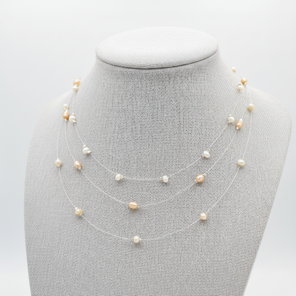 Three Freshwater Pearl necklaces on a mannequin bust against a light gray background.