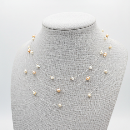 Three Freshwater Pearl necklaces on a mannequin bust against a light gray background.