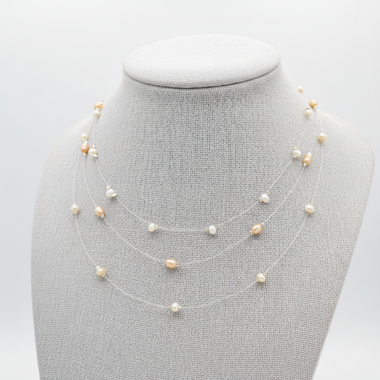 Three Freshwater Pearl necklaces on a mannequin bust against a light gray background.