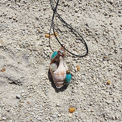 Handmade tulip shell pendant necklace with mixed metal wire wrap, turquoise beads, and wood accents on cord